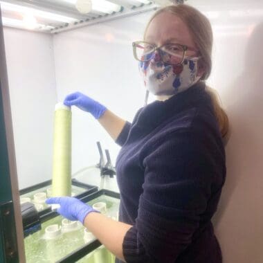 Sarah Adams examining a spool for seaweed spore growth